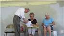 Man Explaining to Women Filling Out Paperwork